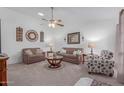 Comfortable living room with neutral color palette and ceiling fan at 8140 N 107Th Ave # 129, Peoria, AZ 85345