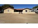 Exterior view of home with dirt driveway, landscaping, and RV at 7706 N 173Rd Ave, Waddell, AZ 85355