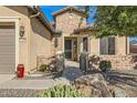 Stone and stucco exterior entryway with a walkway to the front door at 27046 W Yukon Dr, Buckeye, AZ 85396