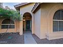 Front entry with arched doorway and teal security door at 3846 N Kings Peak --, Mesa, AZ 85215