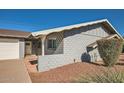 Side view of a gray block home with a walkway and landscaping at 8310 E Devonshire Ave, Scottsdale, AZ 85251