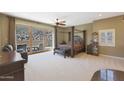 Large bedroom with a four poster bed and access to a patio at 1044 W Indian Hills Pl, Phoenix, AZ 85023