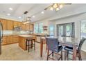 Spacious kitchen with an island, granite countertops, and wooden cabinets at 14462 W Avalon Dr, Goodyear, AZ 85395