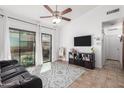 Bright living room with tile floors, a comfortable couch, and a TV at 3030 S Alma School Rd # 12, Mesa, AZ 85210