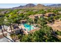 Aerial view of community pool and surrounding homes with mountain backdrop at 3525 N Carlton St, Buckeye, AZ 85396