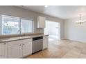 White kitchen cabinets, stainless steel dishwasher, and tile floor at 3743 W Dailey St, Phoenix, AZ 85053