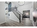 Modern entryway featuring a sleek staircase and an open floor plan at 394 E Redfield Rd, Chandler, AZ 85225