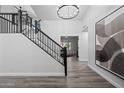 Bright and airy entryway with a modern staircase and large art piece at 394 E Redfield Rd, Chandler, AZ 85225