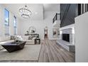 Spacious living room with a cozy fireplace and large windows at 394 E Redfield Rd, Chandler, AZ 85225