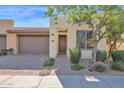 Front view of a charming house with a landscaped yard and a two-car garage at 731 E Verde Blvd, Queen Creek, AZ 85140
