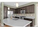 Modern kitchen with stainless steel appliances and a large island at 731 E Verde Blvd, Queen Creek, AZ 85140