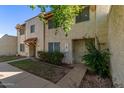 Front view of a tan stucco condo building with walkway and landscaping at 8106 N 31St Dr, Phoenix, AZ 85051