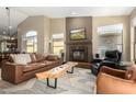 Spacious living room with fireplace and leather furniture at 9625 E Champagne Dr, Sun Lakes, AZ 85248