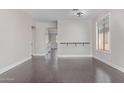 Dining room with dark hardwood floors and view to kitchen at 10768 W Citrus Grove Way, Avondale, AZ 85392