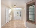 Bright and airy entryway with tile flooring and display cabinet at 9382 E Aster Dr, Scottsdale, AZ 85260