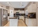 Kitchen with granite countertops, stainless steel appliances, and light wood cabinets at 10726 E Wallflower Ln, Florence, AZ 85132