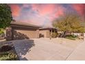 Front view of a house with a two-car garage and gravel driveway at 20972 N Canyon Whisper Dr, Surprise, AZ 85387