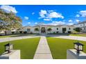 Elegant home exterior with a gated entry and lush landscaping at 2335 E Plum St, Gilbert, AZ 85298