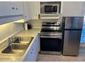 Kitchen features stainless steel appliances and double sink at 2633 W Rose Ln # B214, Phoenix, AZ 85017