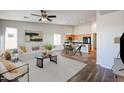 Open living room and kitchen with modern flooring and furnishings at 41208 W Bravo Dr, Maricopa, AZ 85138