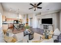 Open living area with kitchen views, hardwood floors, and a neutral color scheme at 41208 W Bravo Dr, Maricopa, AZ 85138