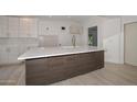 Modern kitchen island with white quartz countertops and dark cabinets at 6312 N 13Th St, Phoenix, AZ 85014