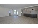 Open living room and kitchen area with light wood-look floors at 6312 N 13Th St, Phoenix, AZ 85014