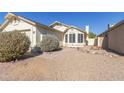 Landscaped front yard with gravel, stone pathway, and shrubs at 8840 W Villa Rita Dr, Peoria, AZ 85382