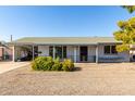 Ranch style home with carport and mature landscaping at 12216 N 107Th Ave, Sun City, AZ 85351