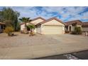 House exterior featuring a two-car garage and drought-tolerant landscaping at 13652 W Fargo Dr, Surprise, AZ 85374