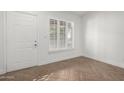 Bright entryway with white door and herringbone floors at 1449 E Highland Ave # 36, Phoenix, AZ 85014