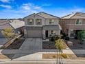 Two-story home with gray siding, neutral accents, and a two-car garage at 16977 W Red Bird Rd, Surprise, AZ 85387