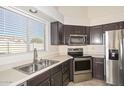 Kitchen with stainless steel appliances and double sink at 20058 N 109Th Dr, Sun City, AZ 85373