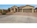One-story home with a two-car garage and landscaped front yard at 22446 E Russet Rd, Queen Creek, AZ 85142