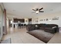 Spacious living room with a large sectional sofa and tile flooring at 22446 E Russet Rd, Queen Creek, AZ 85142