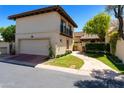 Spanish-style home with a private garage and manicured lawn at 6701 N Scottsdale Rd # 20, Scottsdale, AZ 85250