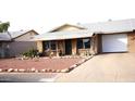 Ranch-style home with a landscaped yard and attached garage at 9616 W Mountain View Rd # A, Peoria, AZ 85345