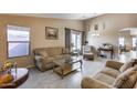 Living room featuring neutral-toned furniture and tile floors at 15547 W Magnolia St, Goodyear, AZ 85338
