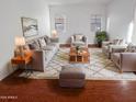 Living room with couches, chairs, and a coffee table at 1948 W Busoni Pl, Phoenix, AZ 85023