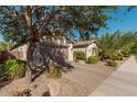 Landscaped front yard with trees and a brick driveway at 20526 E Raven Dr, Queen Creek, AZ 85142