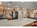 Modern kitchen with granite countertops, stainless steel appliances, and an island at 20566 N Lemon Drop Dr, Maricopa, AZ 85138