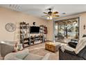 Bright and airy living room with large windows and access to a patio at 20566 N Lemon Drop Dr, Maricopa, AZ 85138