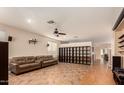 Open living area with tiled floors, a room divider, and a ceiling fan at 41229 W Laramie Rd, Maricopa, AZ 85138