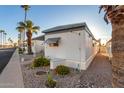 Side view of a white mobile home and palm trees at 44 S Hawes Rd # A15, Mesa, AZ 85208