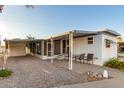 Mobile home with covered patio, table, and chairs at 44 S Hawes Rd # A15, Mesa, AZ 85208