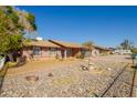 House exterior showcasing a well-maintained yard and a fountain at 7802 W Catalina Dr, Phoenix, AZ 85033