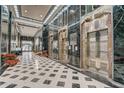 Elegant lobby with marble floors, ornate elevators, and abundant natural light at 114 W Adams St # 506, Phoenix, AZ 85003