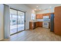 Kitchen features wood cabinets, tile flooring, and stainless steel appliances at 16115 W Acacia Ct, Surprise, AZ 85374