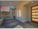 Covered patio with mountain views and a modern front door at 3877 S Veronica Ln, Gold Canyon, AZ 85118