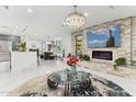 Open concept living area with modern fireplace and large TV at 1101 N Christa Way, Tolleson, AZ 85353